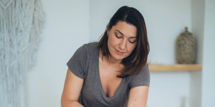 woman lying on bed while massage therapist works