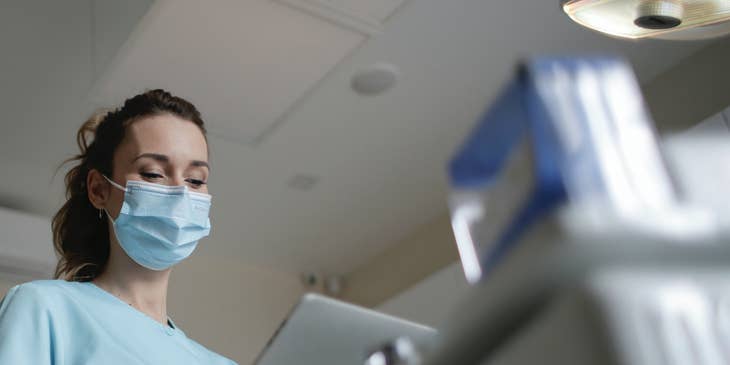medical assistant looking at a patients' chart