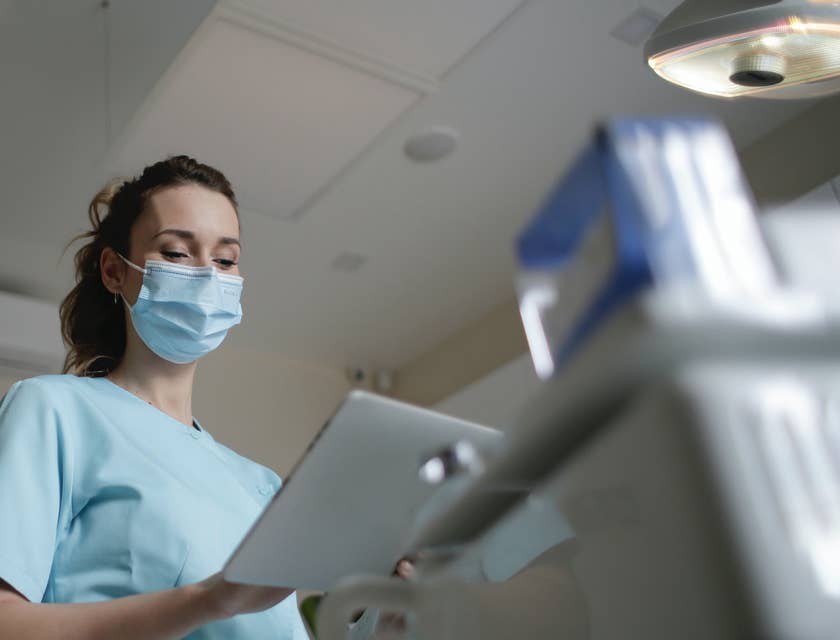 medical assistant looking at a patients' chart