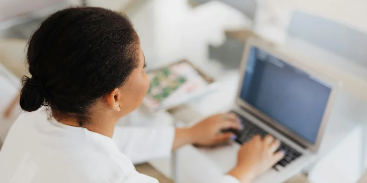 A medical coder inputting patient information into a computer.