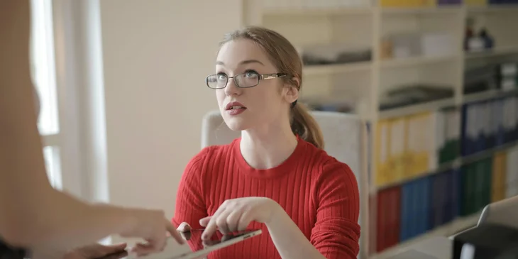 A medical coordinator providing instructions to a coworker.