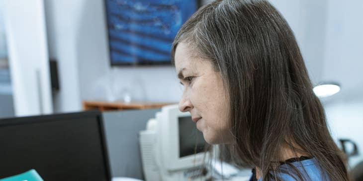 medical receptionist working behind desk