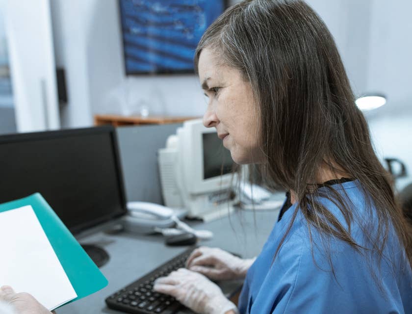 medical receptionist working behind desk