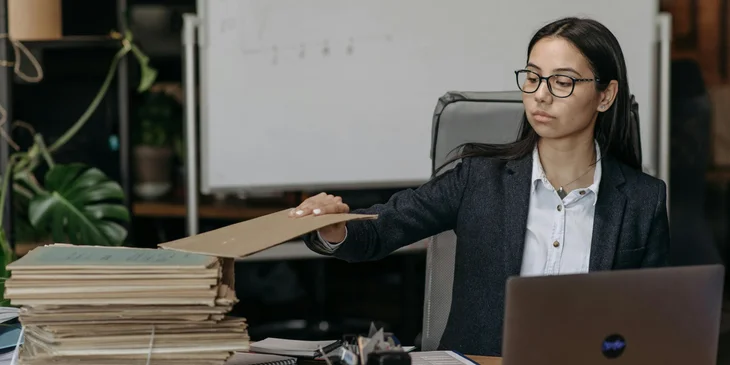 A medical records clerk organizes the records into files for efficient storage.