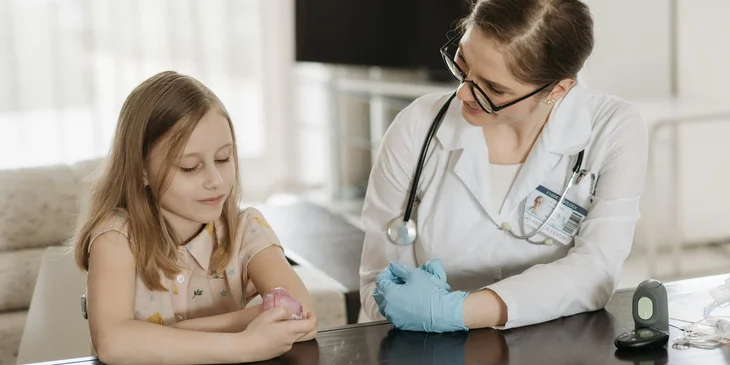 A doctor speaking with a young patient.