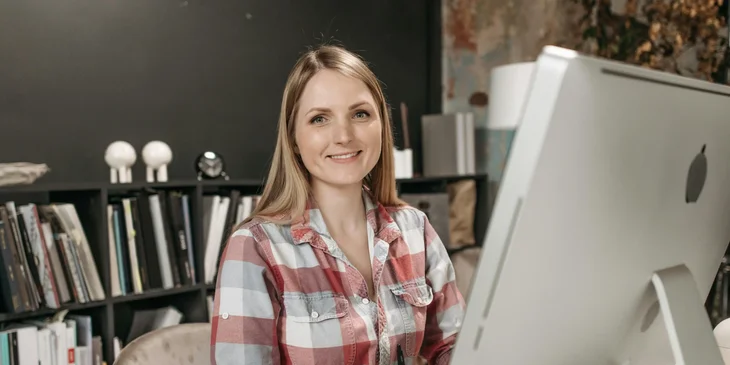 A woman in an office sitting in front of a computer.