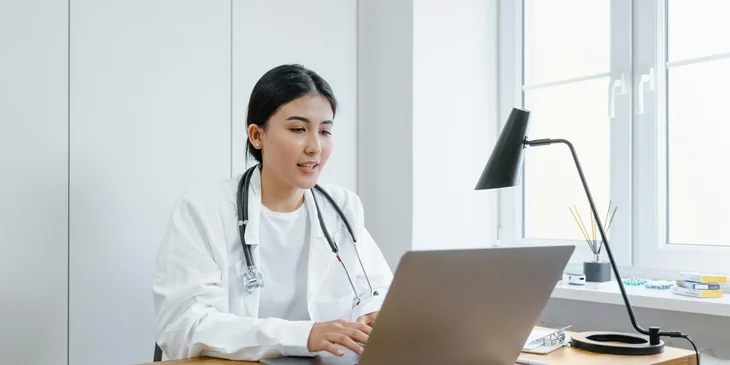 A doctor using her laptop.