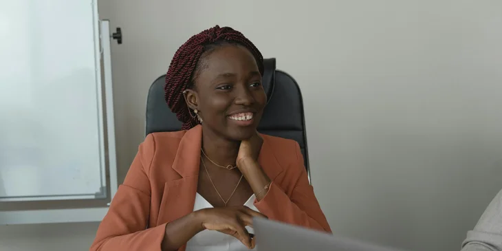 A woman sitting in an office with her colleague.