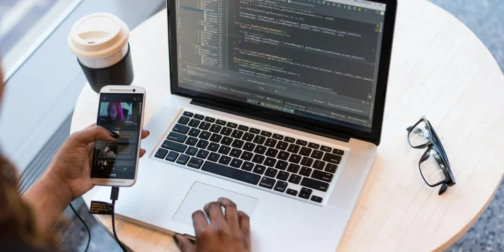 A mobile developer testing the mobile app on their laptop.