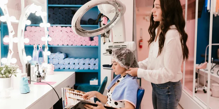 A hairstylist working with a client.
