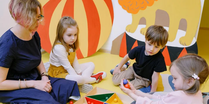 A Montessori teacher guides the students during play.