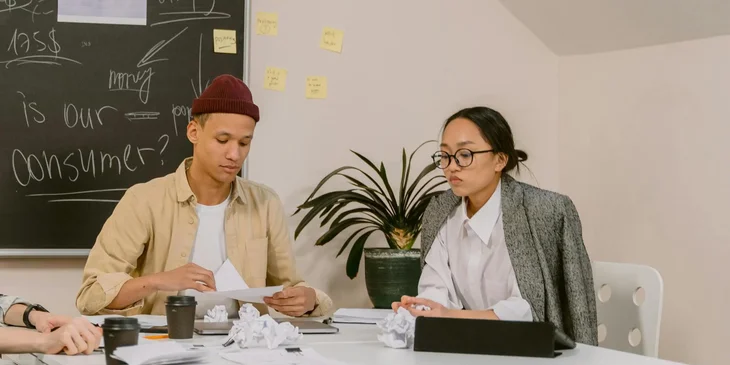 Two coworkers discussing a project.
