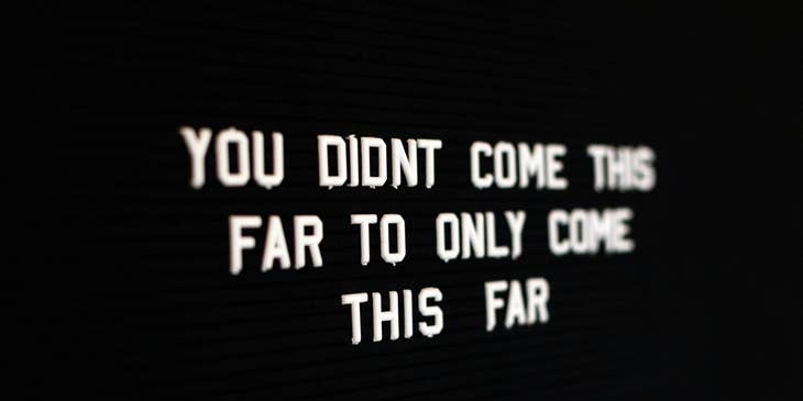 white motivational quote on blackboard