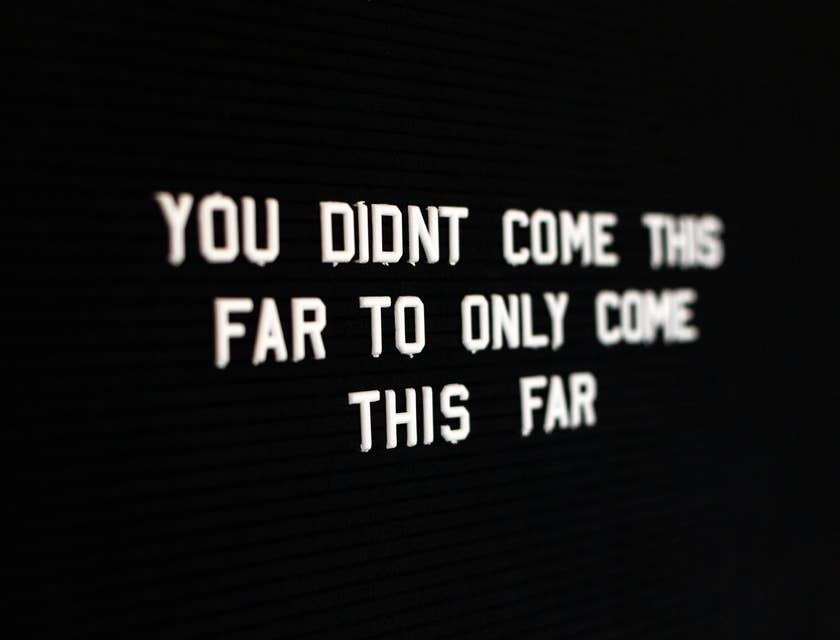 white motivational quote on blackboard