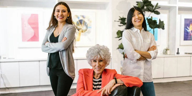 The women posing inside an office.