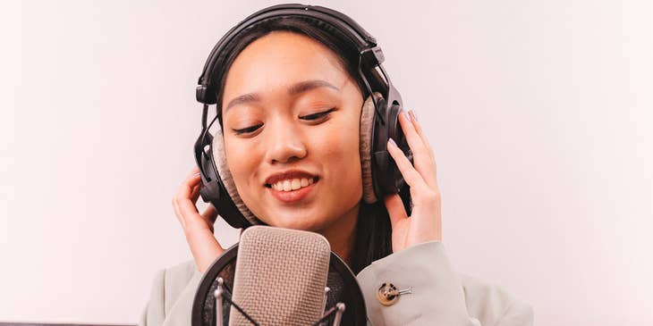 A woman recording music audio.
