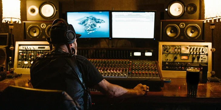 An audio engineer editing music for recording purposes.
