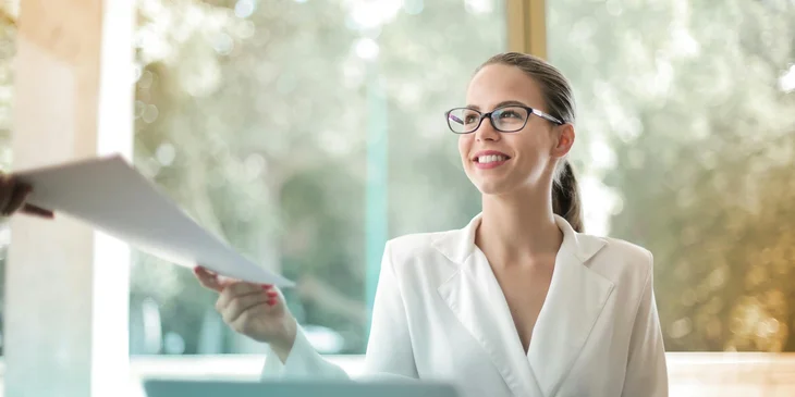 A businesswoman doing paperwork in an office.