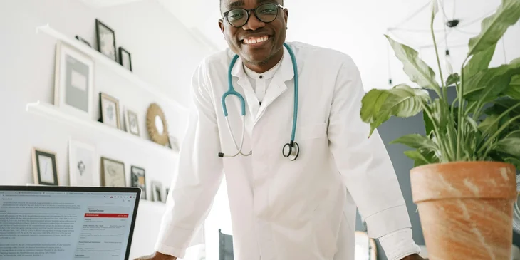 A doctor smiling at a camera.