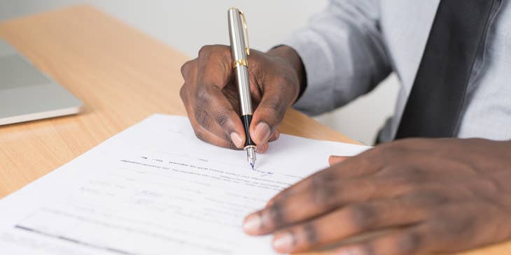A man filling in a new hire form.