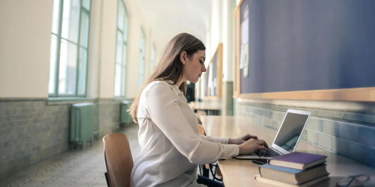 A woman working on her laptop.