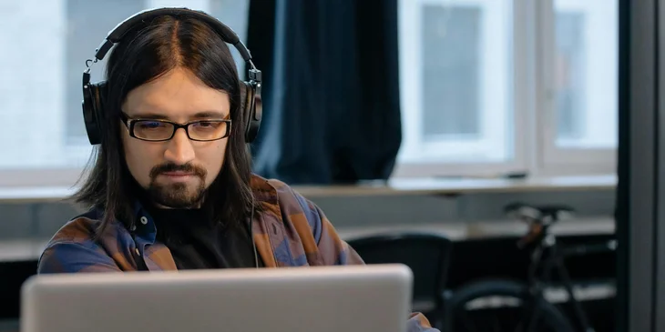 An NOC engineer working on a laptop.