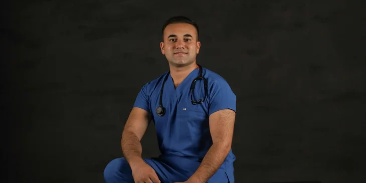 A man wearing a scrub suit.