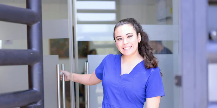 A nurse standing outside a clinic.