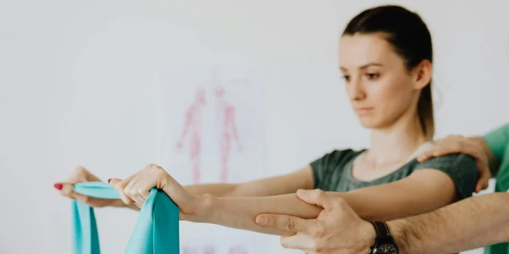 An occupational therapy technician assisting a patient in a therapy session.