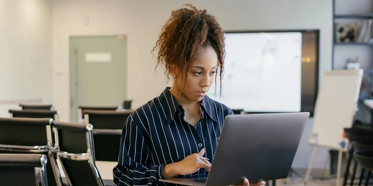 A woman working on her laptop.