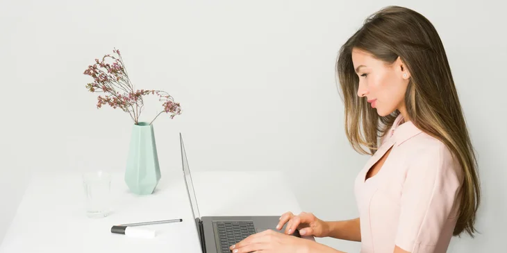 A woman working on her laptop.
