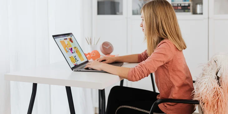 A woman working on her laptop.