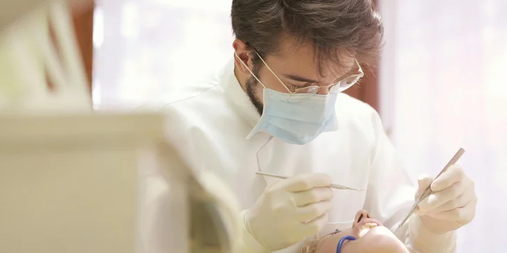 A dentist providing treatment to a patient.