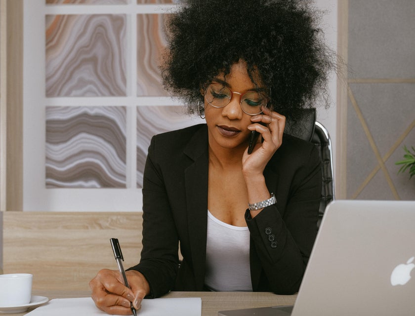 An order clerk on the phone with a customer placing an order.