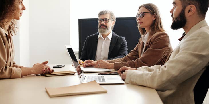 A group of interviewers conducting a panel interview with a prospective candidate.