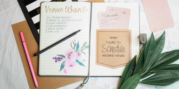A party planner's notes and checklist, along with pens and a clipboard.