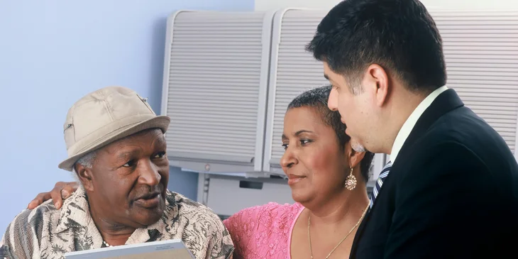 A patient liaison informs the patient's family about their care quality while reviewing insurance coverage.