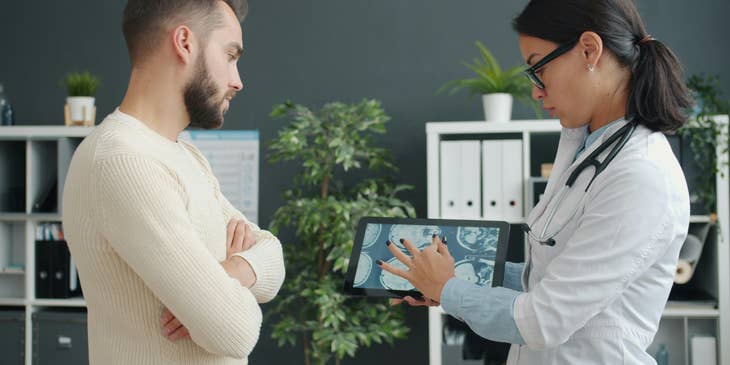 A patient account representative meets with the physician to confirm diagnoses for medical insurance information.