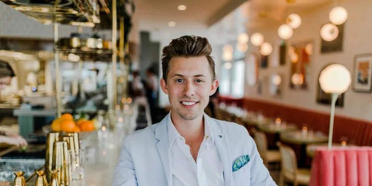 A payroll manager seated in a restaurant.