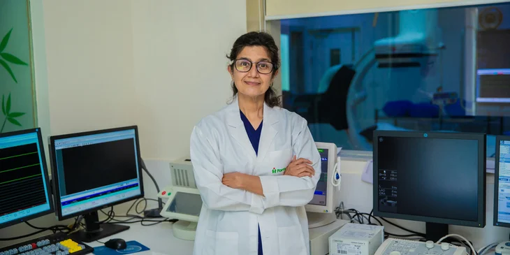 A doctor standing with her arms crossed.