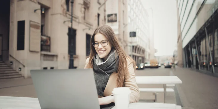 A woman typing on a laptop.