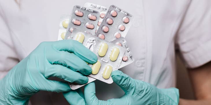 pharmacy technician holding up medication