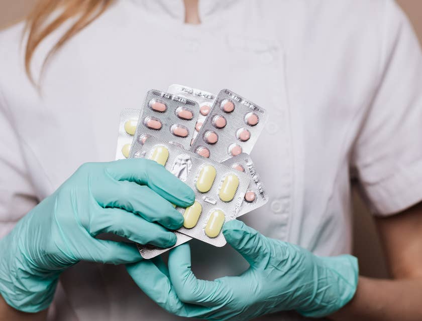 pharmacy technician holding up medication