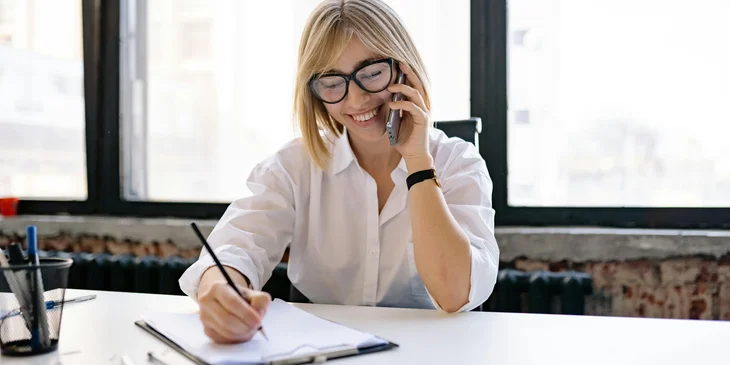 An HR admin conducting a phone interview with a candidate for the position.