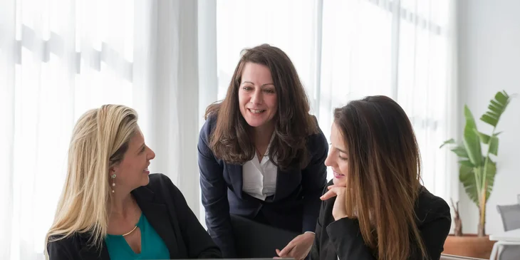 A group of professional women in a meeting.
