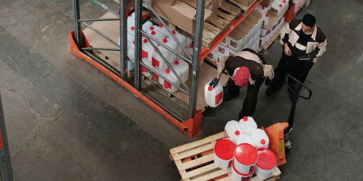 A production supervisor checks the supplies in the storage.