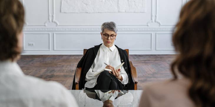 Psychologist making notes in a session