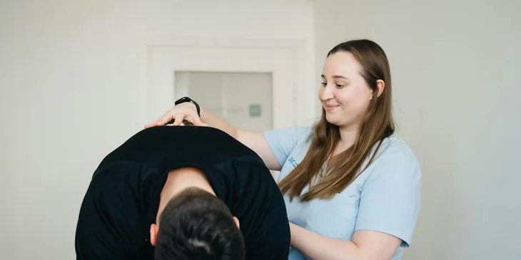 A physical therapist in a session with a patient.