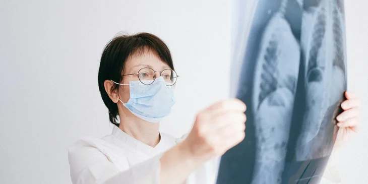 A pulmonologist reviews the X-ray results to determine the diagnosis.