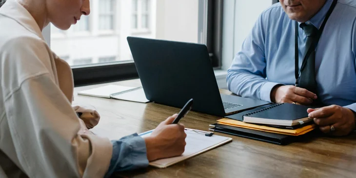 A purchasing specialist in a meeting with a supplier, negotiating the purchase terms and conditions.